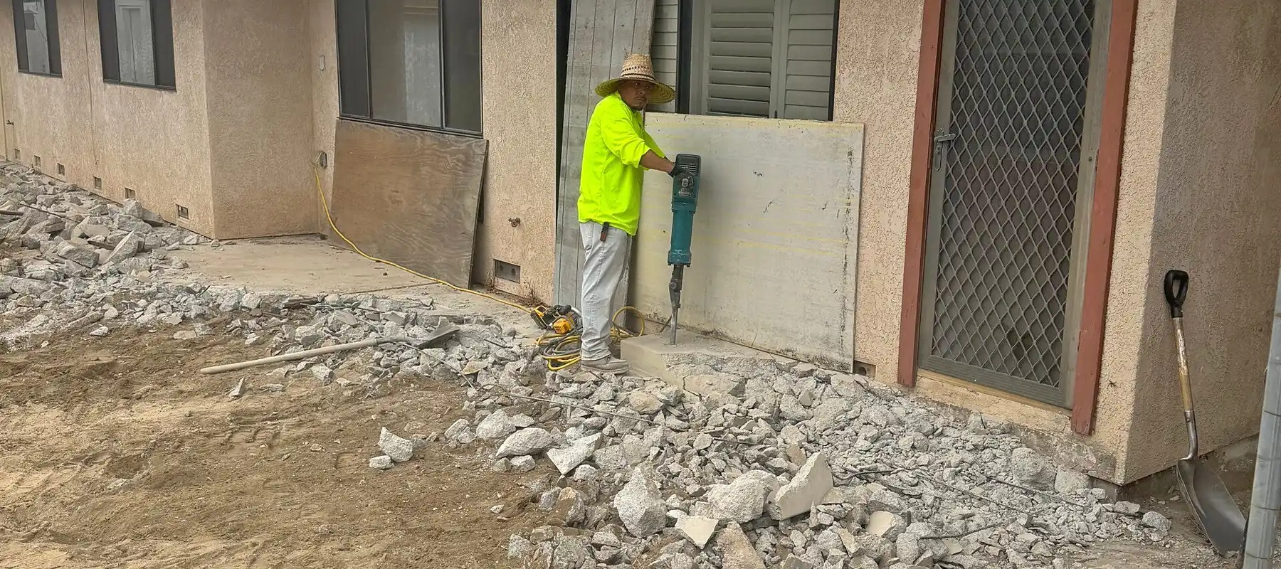 Old concrete patio being broken out and removed before replacement